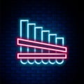 Glowing neon line Pan flute icon isolated on brick wall background. Traditional peruvian musical instrument. Zampona Royalty Free Stock Photo