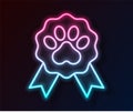 Glowing neon line Pet award symbol icon isolated on black background. Badge with dog or cat paw print and ribbons. Medal Royalty Free Stock Photo