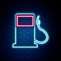 Glowing neon line Petrol or Gas station icon isolated on brick wall background. Car fuel symbol. Gasoline pump. Colorful Royalty Free Stock Photo
