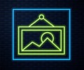 Glowing neon line Picture icon isolated on brick wall background. Vector