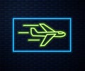 Glowing neon line Plane icon isolated on brick wall background. Flying airplane icon. Airliner sign. Vector Royalty Free Stock Photo