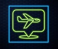 Glowing neon line Plane icon isolated on brick wall background. Flying airplane icon. Airliner sign. Vector Royalty Free Stock Photo