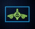 Glowing neon line Plane icon isolated on brick wall background. Flying airplane icon. Airliner sign. Vector Royalty Free Stock Photo