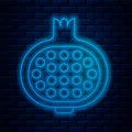 Glowing neon line Pomegranate icon isolated on brick wall background. Garnet fruit. Vector