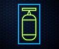 Glowing neon line Punching bag icon isolated on brick wall background. Vector Illustration