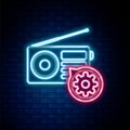 Glowing neon line Radio with antenna and gear icon isolated on brick wall background. Adjusting app, service concept Royalty Free Stock Photo