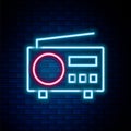 Glowing neon line Radio with antenna icon isolated on brick wall background. Colorful outline concept. Vector Royalty Free Stock Photo