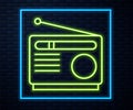 Glowing neon line Radio with antenna icon isolated on brick wall background. Vector Royalty Free Stock Photo