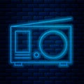 Glowing neon line Radio with antenna icon isolated on brick wall background. Vector Illustration Royalty Free Stock Photo