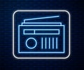 Glowing neon line Radio with antenna icon isolated on brick wall background. Vector Illustration Royalty Free Stock Photo