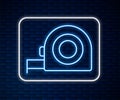 Glowing neon line Roulette construction icon isolated on brick wall background. Tape measure symbol. Vector