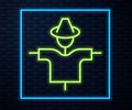 Glowing neon line Scarecrow icon isolated on brick wall background. Vector