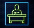 Glowing neon line Schoolboy sitting at desk icon isolated on brick wall background. Vector