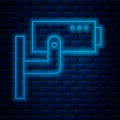 Glowing neon line Security camera icon isolated on brick wall background. Vector Illustration Royalty Free Stock Photo