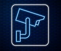 Glowing neon line Security camera icon isolated on brick wall background. Vector Illustration Royalty Free Stock Photo