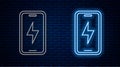 Glowing neon line Smartphone charging battery icon isolated on brick wall background. Phone with a low battery charge Royalty Free Stock Photo