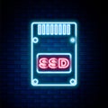 Glowing neon line SSD card icon isolated on brick wall background. Solid state drive sign. Storage disk symbol. Colorful Royalty Free Stock Photo