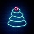 Glowing neon line Stack hot stones icon isolated on brick wall background. Spa salon accessory. Colorful outline concept Royalty Free Stock Photo