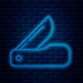 Glowing neon line Swiss army knife icon isolated on brick wall background. Multi-tool, multipurpose penknife