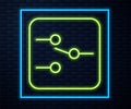 Glowing neon line Switch in electronic circuit icon isolated on brick wall background. Vector