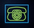 Glowing neon line Telephone icon isolated on brick wall background. Landline phone. Vector Illustration Royalty Free Stock Photo