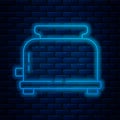 Glowing neon line Toaster with toasts icon isolated on brick wall background. Vector