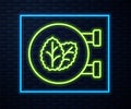 Glowing neon line Tobacco leaf shop icon isolated on brick wall background. Tobacco leaves. Vector