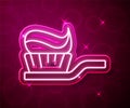 Glowing neon line Toothbrush with toothpaste icon isolated on red background. Vector Royalty Free Stock Photo