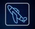 Glowing neon line Toy plane icon isolated on brick wall background. Flying airplane icon. Airliner sign. Vector Royalty Free Stock Photo