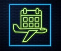 Glowing neon line Travel planning calendar and airplane icon isolated on brick wall background. A planned holiday trip