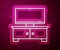 Glowing neon line TV table stand icon isolated on red background. Vector Royalty Free Stock Photo