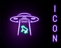 Glowing neon line UFO abducts cow icon isolated on black background. Flying saucer. Alien space ship. Futuristic unknown Royalty Free Stock Photo