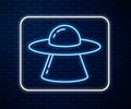 Glowing neon line UFO flying spaceship icon isolated on brick wall background. Flying saucer. Alien space ship. Futuristic unknown Royalty Free Stock Photo