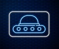 Glowing neon line UFO flying spaceship icon isolated on brick wall background. Flying saucer. Alien space ship Royalty Free Stock Photo