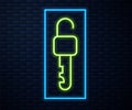 Glowing neon line Unlocked key icon isolated on brick wall background. Vector