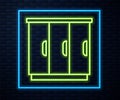 Glowing neon line Wardrobe icon isolated on brick wall background. Cupboard sign. Vector