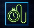 Glowing neon line Watch with a chain icon isolated on brick wall background. Vector