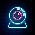 Glowing neon line Web camera icon isolated on brick wall background. Chat camera. Webcam icon. Colorful outline concept