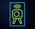 Glowing neon line Web camera icon isolated on brick wall background. Chat camera. Webcam icon. Vector