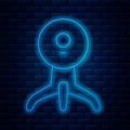 Glowing neon line Web camera icon isolated on brick wall background. Chat camera. Webcam icon. Vector Illustration