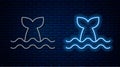 Glowing neon line Whale tail in ocean wave icon isolated on brick wall background. Vector