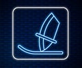 Glowing neon line Windsurfing icon isolated on brick wall background. Vector