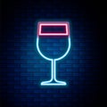 Glowing neon line Wine glass icon isolated on brick wall background. Wineglass icon. Goblet symbol. Glassware sign Royalty Free Stock Photo