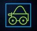 Glowing neon line Wooden four-wheel cart with hay icon isolated on brick wall background. Vector Royalty Free Stock Photo