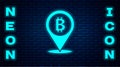 Glowing neon Location bitcoin icon isolated on brick wall background. Physical bit coin. Blockchain based secure crypto