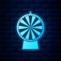 Glowing neon Lucky wheel icon isolated on brick wall background. Vector