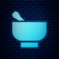 Glowing neon Magic mortar and pestle icon isolated on brick wall background Royalty Free Stock Photo