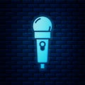 Glowing neon Microphone icon isolated on brick wall background. On air radio mic microphone. Speaker sign. Vector Royalty Free Stock Photo