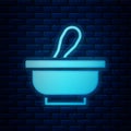 Glowing neon Mortar and pestle icon isolated on brick wall background. Vector Royalty Free Stock Photo