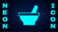 Glowing neon Mortar and pestle icon isolated on brick wall background. Vector Royalty Free Stock Photo